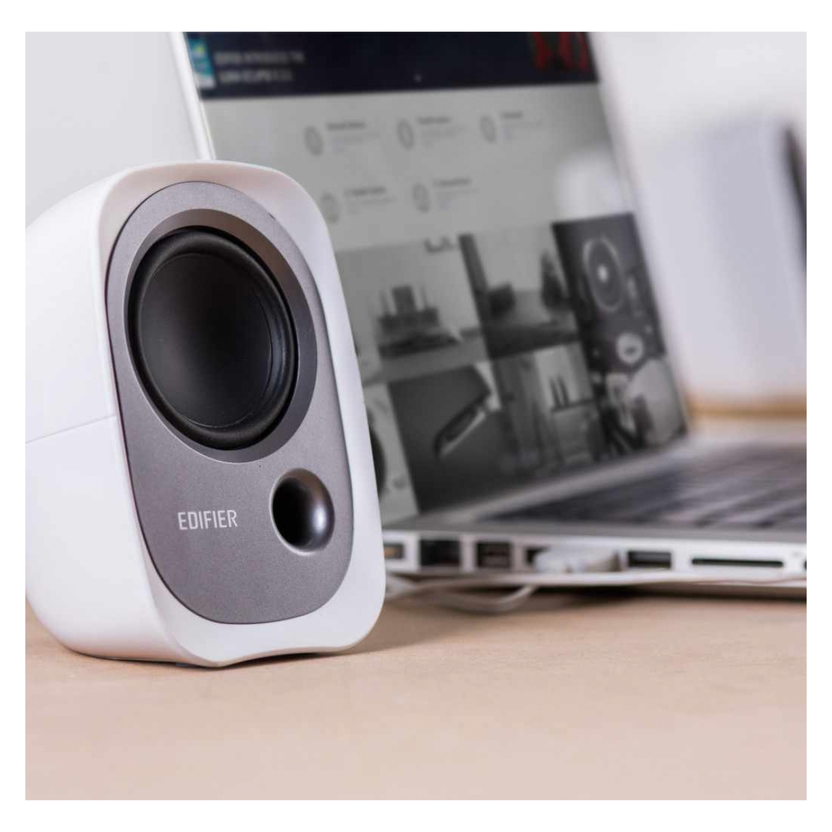 Edifier R12U speakers on desk next to laptop